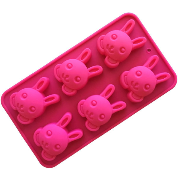 magenta coloured silicone mould with six identical bunny rabbit face cavities