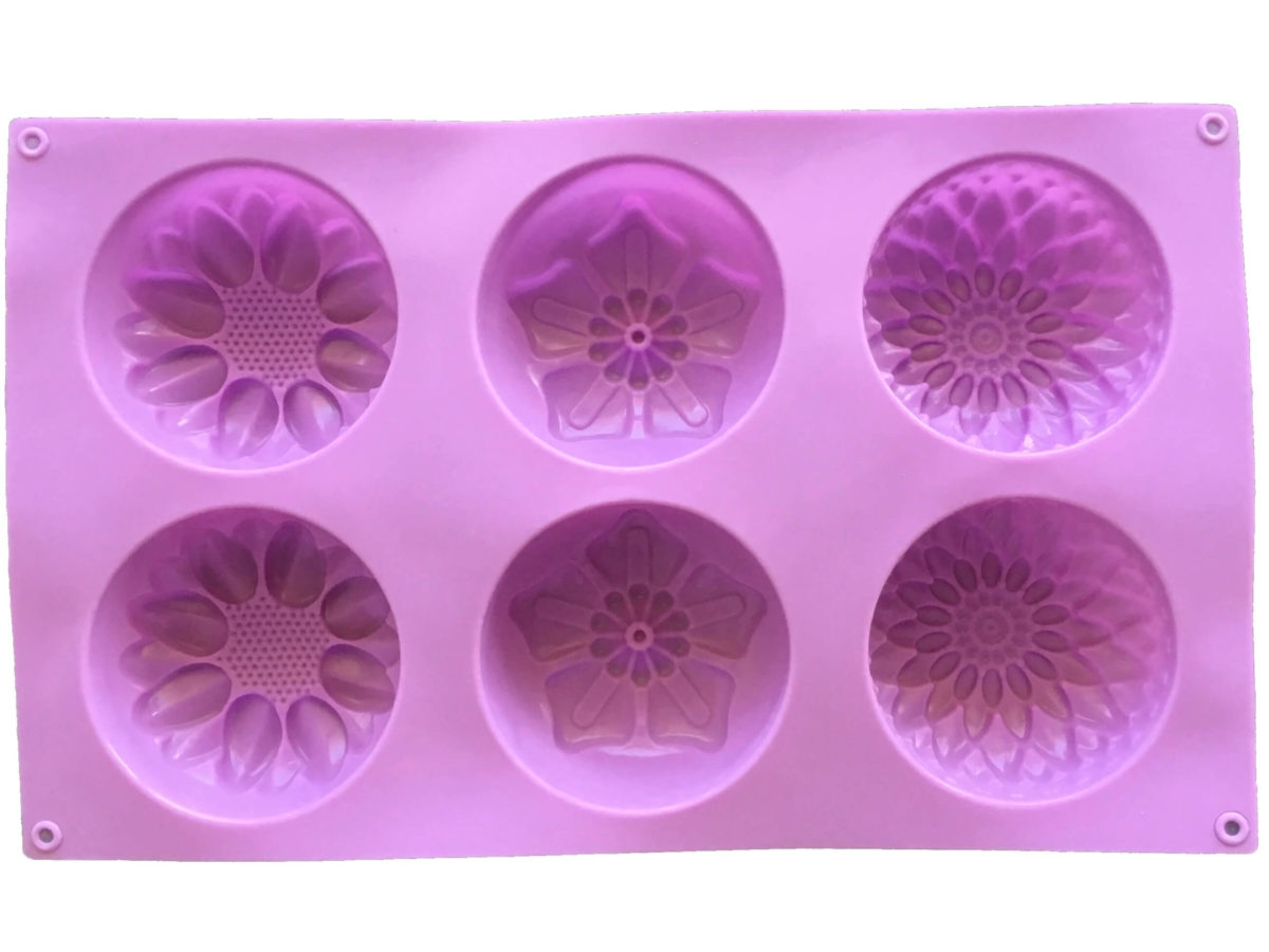 back of large purple silicone mould with six cavites - two each of dahlia, poinsettia and calendula flowers showing mould cavity details