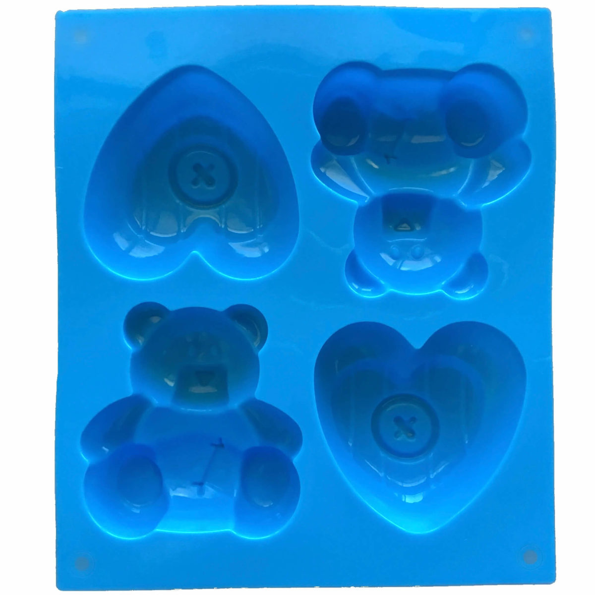 back of large blue silicone mould with four cavites - two each of toy teddy bear and a heart with a button in the middle showing mould cavity details
