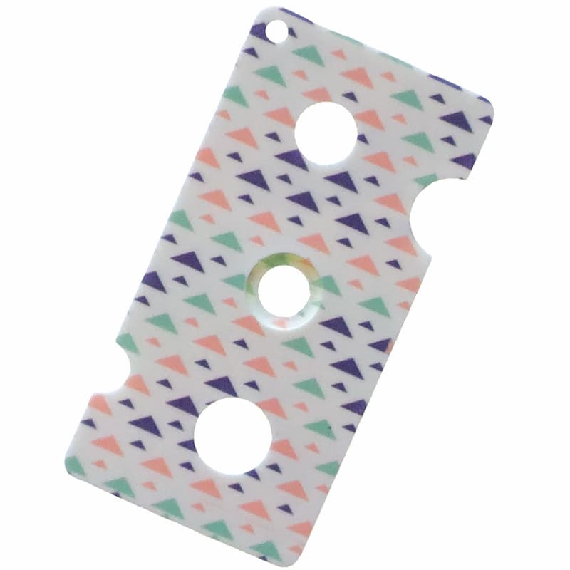 white plastic essential oil bottle key with pink, blue and green triangle motif