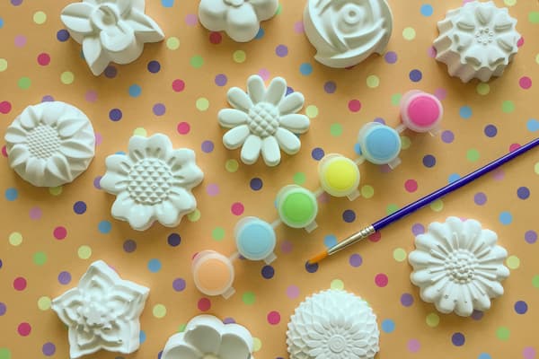 plaster flowers with a paint brush and paint palette