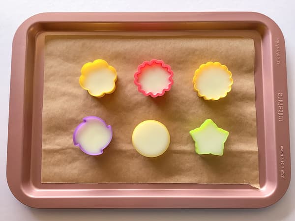 floral silicone moulds filled with lotion bar mix