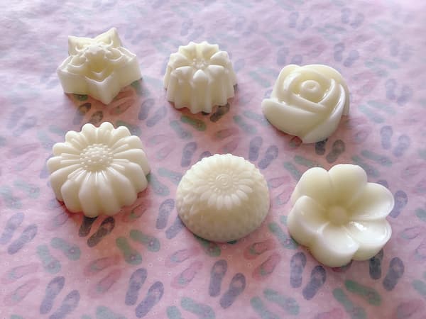 six floral lotion bars laid out on a pretty background